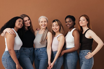 multi-ethnic-group-of-women-of-different-ages-posing-against-brown-background-looking-at-3171775522